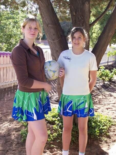 Gold Coast Suns AFLW player Jasmyn Hewett pictured with sister Monique (left) in 2007 before their first netball grand final together. Picture: Supplied.