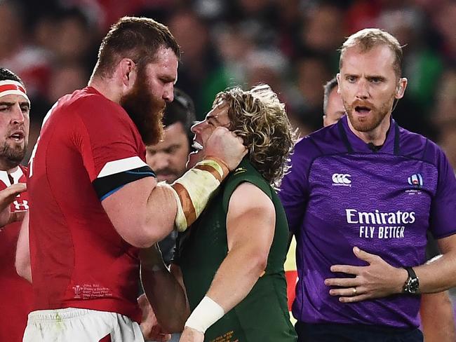 Wales' lock Jake Ball talks to South Africa's scrum-half Faf de Klerk (2nd R) during the Japan 2019 Rugby World Cup semi-final match between Wales and South Africa at the International Stadium Yokohama in Yokohama on October 27, 2019. (Photo by CHARLY TRIBALLEAU / AFP)