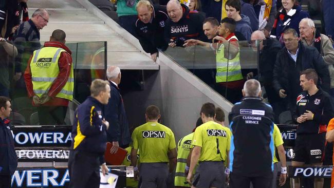 Fans hurl abuse at AFL umpires at Etihad Stadium.