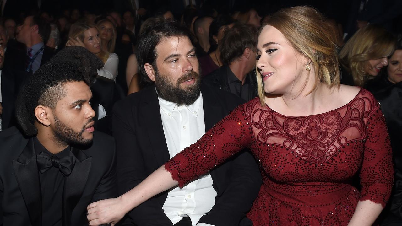 Adele (R) and her husband, charity entrepreneur Simon Konecki (centre) chat to The Weeknd at the 2016 Grammys. Picture: AFP