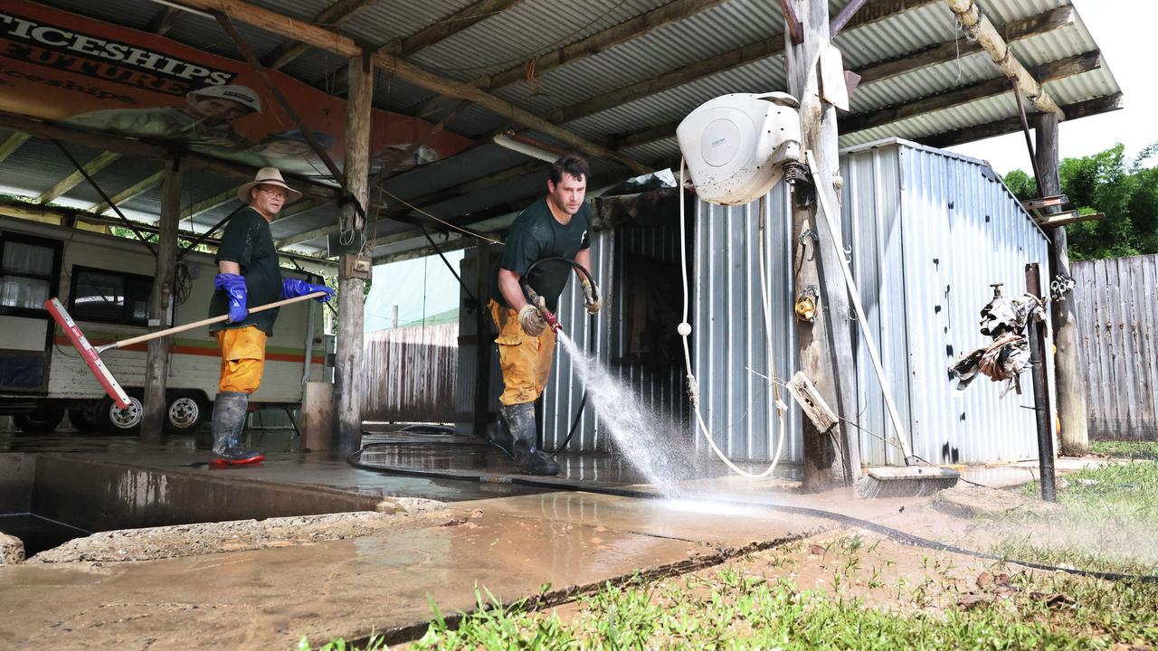 Health officials are unsure why there has been a sharp increase in melioidosis, commonly associated with flooding. Rural Fire Brigade members Mark Schermer and Tyson Pringle hose out a flooded shed in the backyard of a Gregory Street home in Cardwell. Picture: Brendan Radke