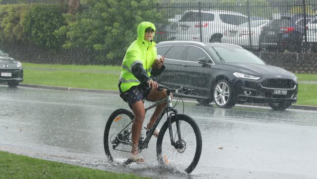 Caught in the rain at Runaway Bay. Picture: Glenn Hampson.