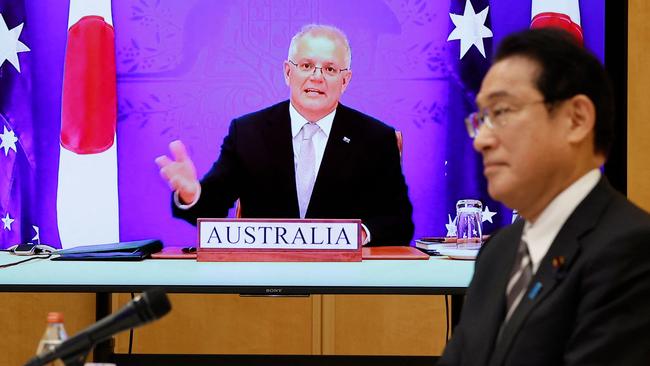 Japan's Prime Minister Fumio Kishida and Scott Morrison attend a video signing ceremony of the bilateral reciprocal access agreement. Picture: AFP