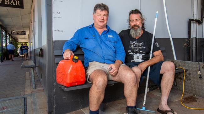 Exhausted but soldiering on, Terry Phyland and Beefy Kovacs are donating their time to pump out water from underneath the Mannum Hotel. Picture: Ben Clark