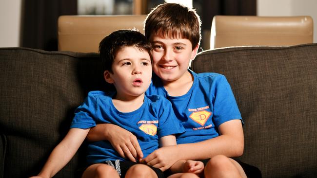 Henry Dray 7, battles with the rare disease Dup15q. Pictured with brother William Dray 10 and their designed t-shirts for 'Superheroes for Super Dupers' . Picture: Alix Sweeney