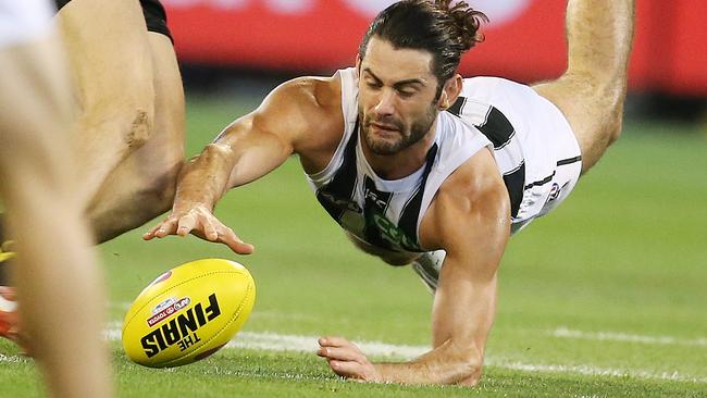 Collingwood big man Brodie Grundy dives on the loose ball on Friday night. Picture: Michael Klein