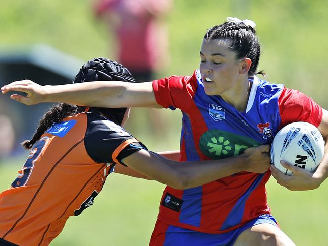 Summer Dowell tries to evade the tackle of Layla Tima. Picture: Michael Gorton