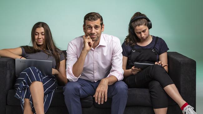 Dr Justin Coulson with Ella, 16, and Abbie, 17. Picture: Mark Cranitch