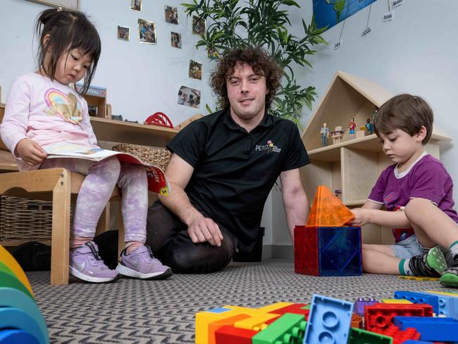 Dylan Knoll, who is in his second year of a teaching degree, is encouraging other males to get into the profession. Dylan with Fiona (4) and Fletcher (4). Picture: Tony Gough