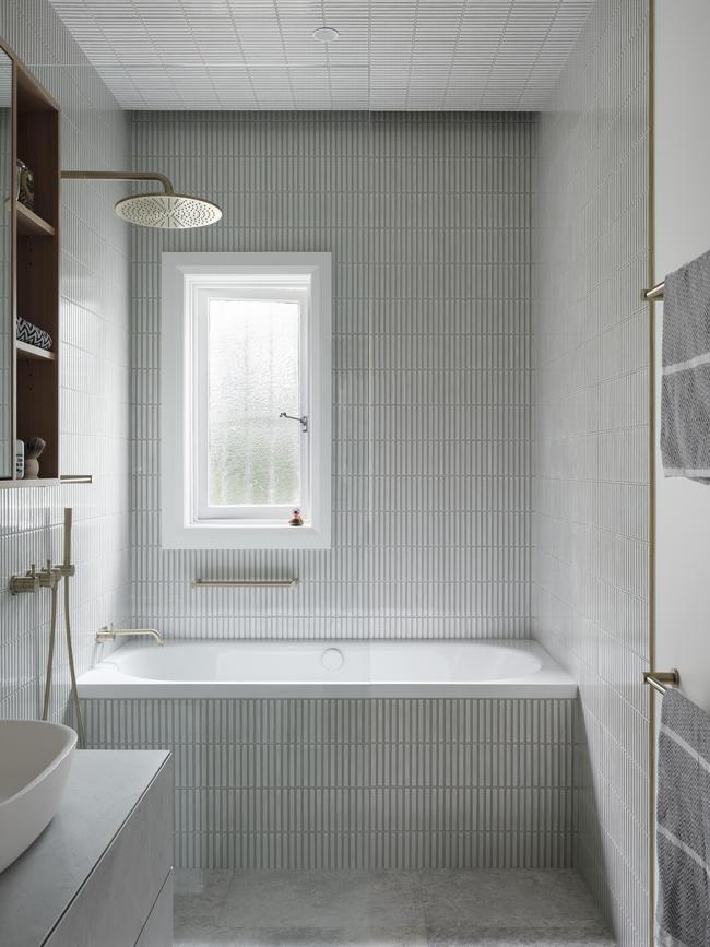 Gold hardware adds a natural shine to the bathroom.