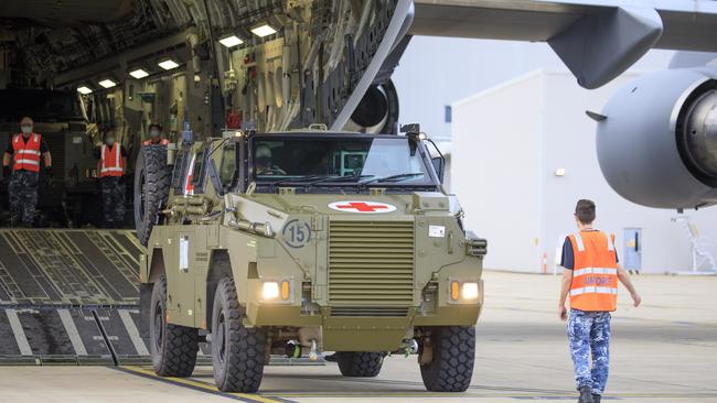 A Bushmaster Protected Mobility Vehicle bound for Ukraine is reversed onto a C-17A Globemaster III aircraft, at RAAF Base Amberley, Queensland.