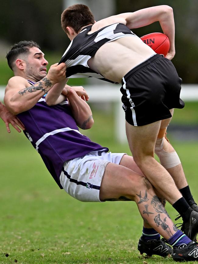 Brunswick’s Reubin Fulton-Grigg wraps up Ivanhoe’s Connor O'Brien. Picture: Andy Brownbill