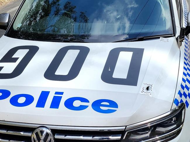 A bullet hole on the bonnet of a police car involved in the pursuit.