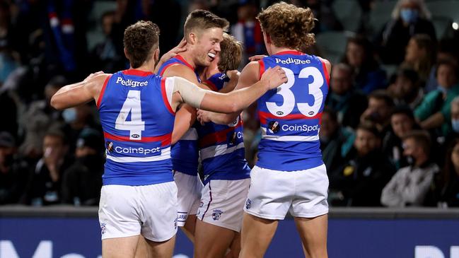 Josh Schache gets a hug from teammates during the Dogs’ preliminary final win.