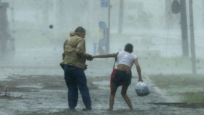 A man helps a woman make her way through flood waters in Pascagoula, Mississippi on August 29.