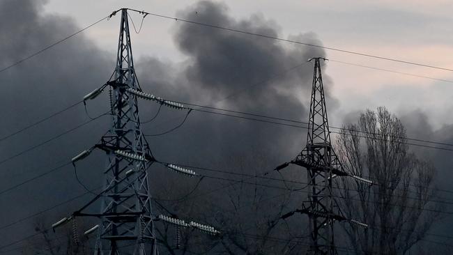 Smoke billows near electricity towers after a Russian missile strike in Kyiv.