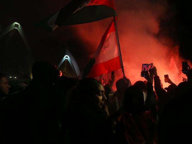 Palestine supporters ignite flares outside the Sydney Opera House. Picture: Getty