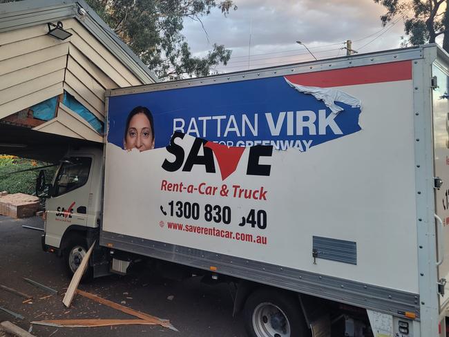 Multiple men were been seen tearing campaign signage for Liberal Greenway candidate Rattan Virk from a truck crashed into the Quakers Hill Community Centre polling booth. Picture: Supplied