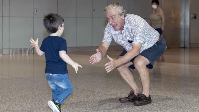 Alan Kinkade, at Sydney airport, is reunited with grandson Tom, who lives in Melbourne. Picture: Getty Images