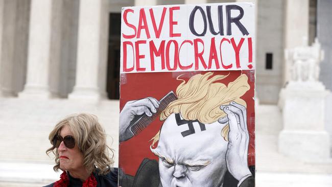 Local resident Nicky Sundt holds a sign that read “Save Our Democracy” in front of the U.S. Supreme Court on March 4, 2024 in Washington, DC. Picture: Alex Wong/Getty Images/AFP)