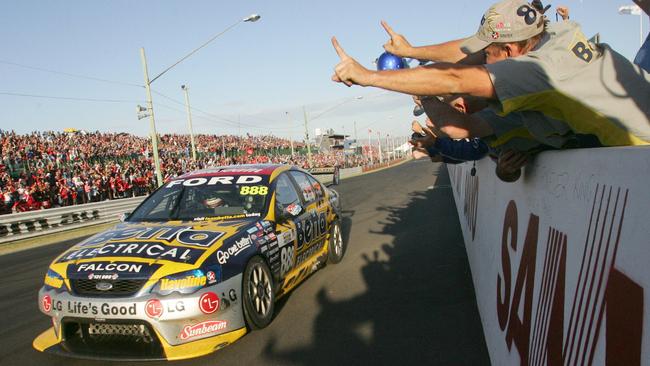 Finish of race won by Craig Lowndes and Jamie Whincup from the Team Betta Electrical in 2006. Pit crew members cheer Craig Lowndes as he wins the race.