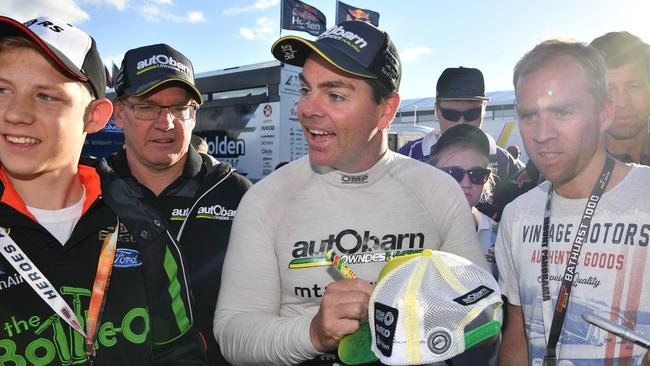 Craig Lowndes signs autographs at Mt Panorama on Saturday. Picture: AAP