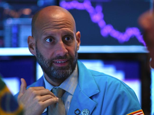 Traders work during the opening bell at the New York Stock Exchange (NYSE) as shares fall. Picture: AFP