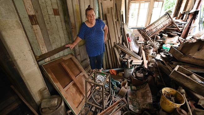 Marian Baund surveys the flood damage at her home in the Brisbane suburb of Rocklea; 10 years after the event, she still can’t face cleaning up. Picture: Lyndon Mechielsen