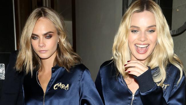 Cara Delevingne and Margot Robbie took the trackies trend a step further ... by having them custom-stitched with their first names. Picture: Splash