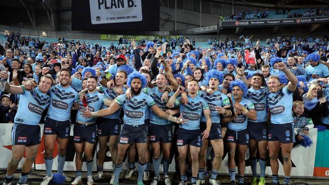 Blues players celebrate victory with fans at ANZ Stadium. Photo: Brett Costello