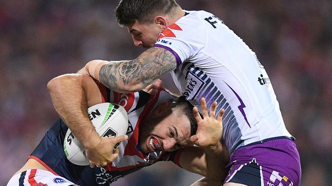 James Tedesco runs into Storm star Curtis Scott on Saturday night.