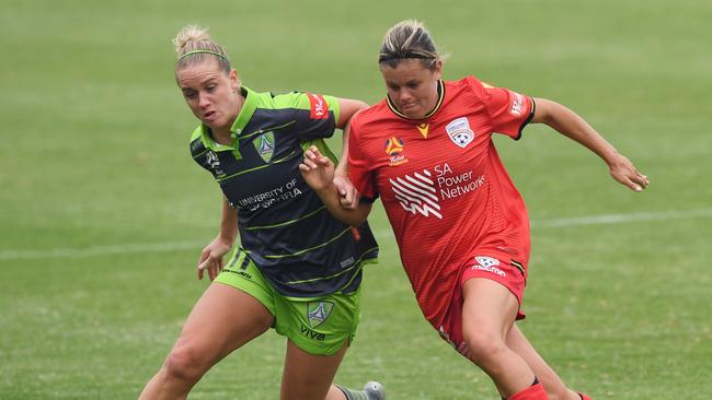 ADELAIDE, AUSTRALIA - DECEMBER 22: Elise Thorsnes of Canberra United competes with Kahlia Hogg of Adelaide United during the round six W-League match between Adelaide United and Canberra United at Marden Sports Complex on December 22, 2019 in Adelaide, Australia. (Photo by Mark Brake/Getty Images)