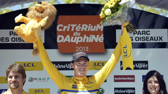 Australia's Rohan Dennis celebrates after putting on the yellow jersey.