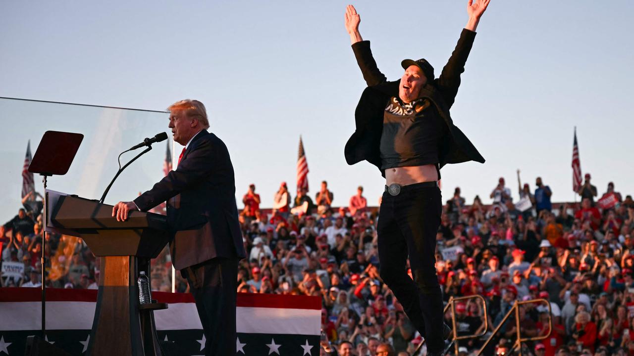 Tesla CEO Elon Musk jumps on stage as he joins former US President and Republican presidential candidate Donald Trump during a campaign rally at site of his first assassination attempt in Butler, Pennsylvania, on October 5. Picture: Jim Watson/AFP