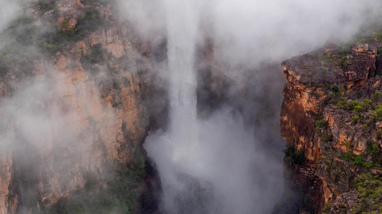 Kakadu National Park comes alive during the wet season. Kakadu Air are celebrating their 40th anniversary of flying in the Territory and relish the opportunity to show the NT News a new perspective of the park after rainfall. Jim Jim Falls is shrouded in cloud in the morning light. Picture: Che Chorley