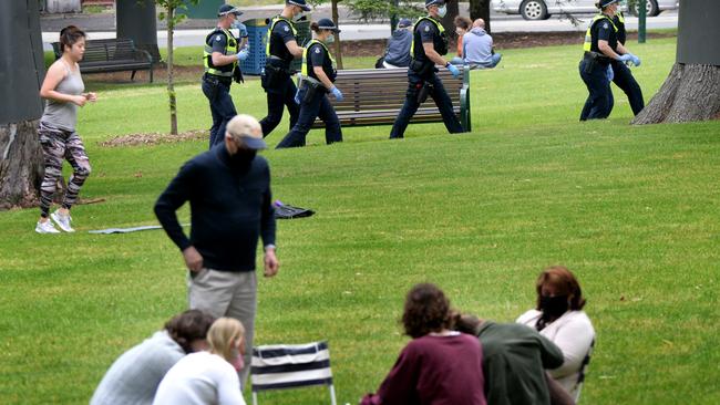 Police patrol the Treasury Gardens on Friday. Picture: Andrew Henshaw