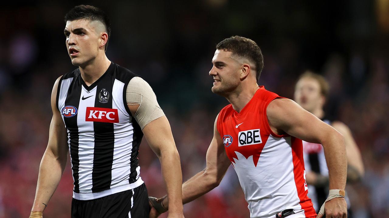 Brayden Maynard of the Magpies is patted by Tom Papley of the Swans. Picture: Mark Kolbe