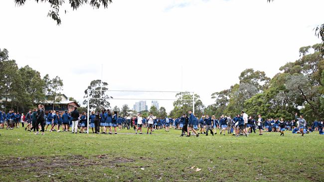 Students of the lawn of Castle Hill High School after it had to be evacuated over email threats. Picture: Adam Yip