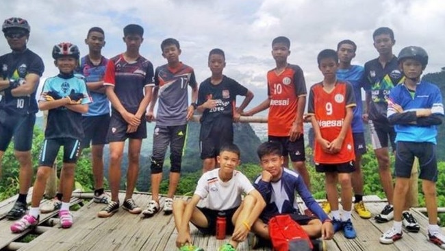 The Wild Boars soccer team, with coach Ekkapol Chantawong at left.