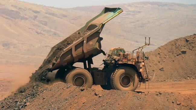 An autonomous haul truck dumps a load of rock in the mine pit at Rio Tinto Group's Gudai-Darri iron ore mine in the Pilbara region of Western Australia, Australia, on Thursday, Oct. 19, 2023. Rio Tinto is preparing for trials of battery-powered locomotives in Australia, where it uses giant autonomous trains — the world’s largest and longest robots — to transport iron ore across the vast Outback. Photographer: Carla Gottgens/Bloomberg