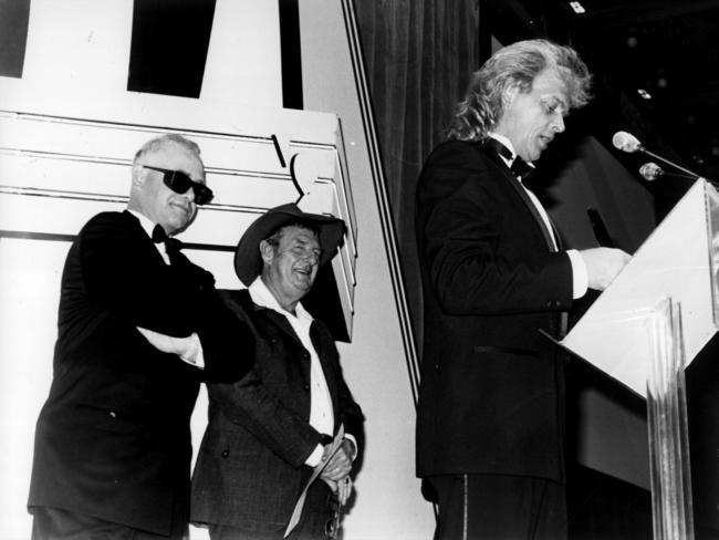 Singer John Farnham accepts an ARIA Award with singers Slim Dusty and Elton John at the inaugural ARIA Awards in Sydney in 1987. Picture: News Corp Australia