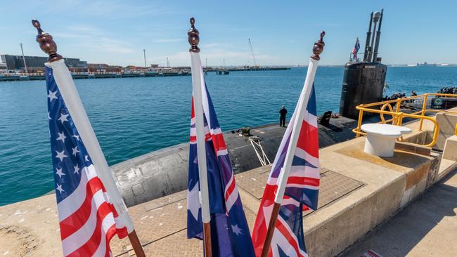 National flags of the US, Australia and Britain in front of USS Asheville, a Los Angeles-class nuclear powered fast attack submarine, at HMAS Stirling. NCA NewsWire / Richard Wainwright