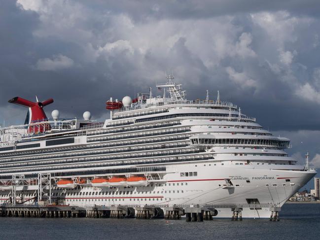 (FILES) In this file photo taken on March 7, 2020 A Carnival Panorama cruise ship is seen docked in Long Beach, California on, as passengers await onboard for the results of a COVID-19 (Coronavirus) test given to an ill passenger. - Carnival Cruise Line announced on May 4, 2020 that it will resume limited operations from Florida and Texas on August 1 after halting cruises because of the coronavirus pandemic which left some passengers trapped on its ships for weeks. (Photo by Mark RALSTON / AFP)