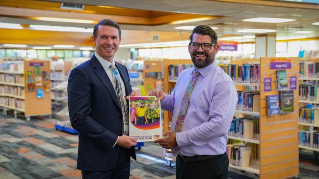 Alice Springs Town Council chief executive Andrew Wilsmore and Mayor Matt Paterson hold the council's 2025/26 draft budget in the Alice Springs Library. Picture: Alice Springs Town Council