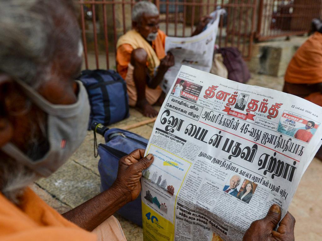 Villagers read newspapers featuring front-page news on Mr Biden and Ms Harris in Mannargudi, Tamil Nadu, southern India. Picture: Arun Sankar / AFP