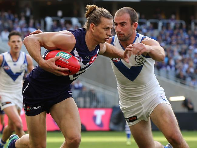 PERTH, AUSTRALIA - MAY 27: Nathan Fyfe of the Dockers fends off a tackle by Ben Cunnington of the Kangaroos during the round 10 AFL match between the Fremantle Dockers and the North Melbourne Kangaroos at Optus Stadium on May 27, 2018 in Perth, Australia.  (Photo by Paul Kane/Getty Images)