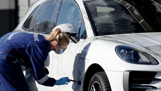 Forensics dust a Porsche for evidence after the Friday-night shooting. Picture: Andrew Henshaw