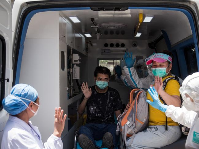 The last patient recovered from COVID-19 at Wuhan pulmonary hospital, second left, leaves the facility. Picture: AFP