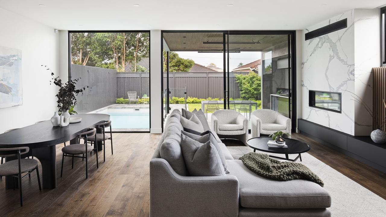 The open-plan living and dining space flows into the back yard.