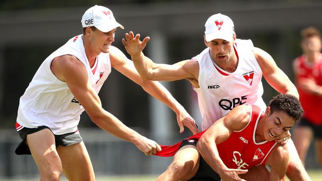 Jordan Dawson and Robbie Fox tackle Zac Foot at Sydney’s pre-season training. Picture: Phil Hillyard